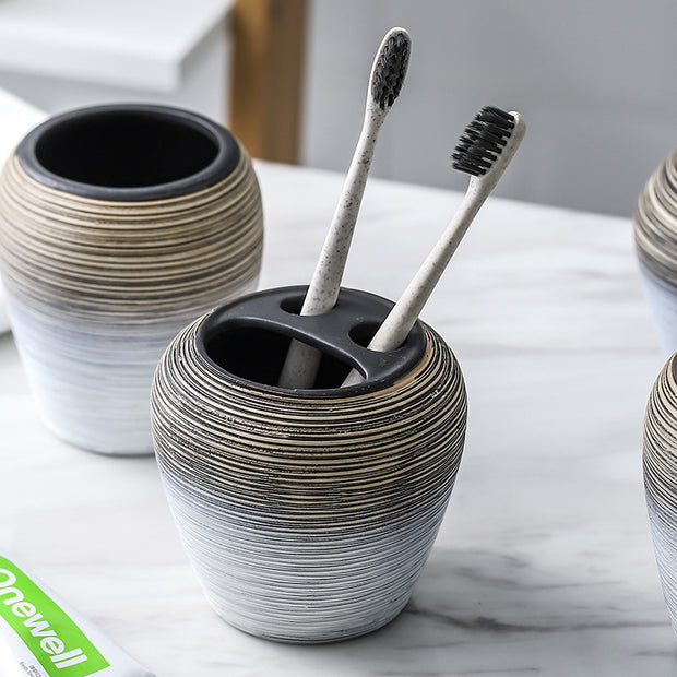 Retro brushed bathroom wash set featuring a stylish toothbrush holder with two toothbrushes.
