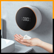Automatic induction hand sanitizer machine dispensing rich foam into a hand, showcasing modern design and digital display.